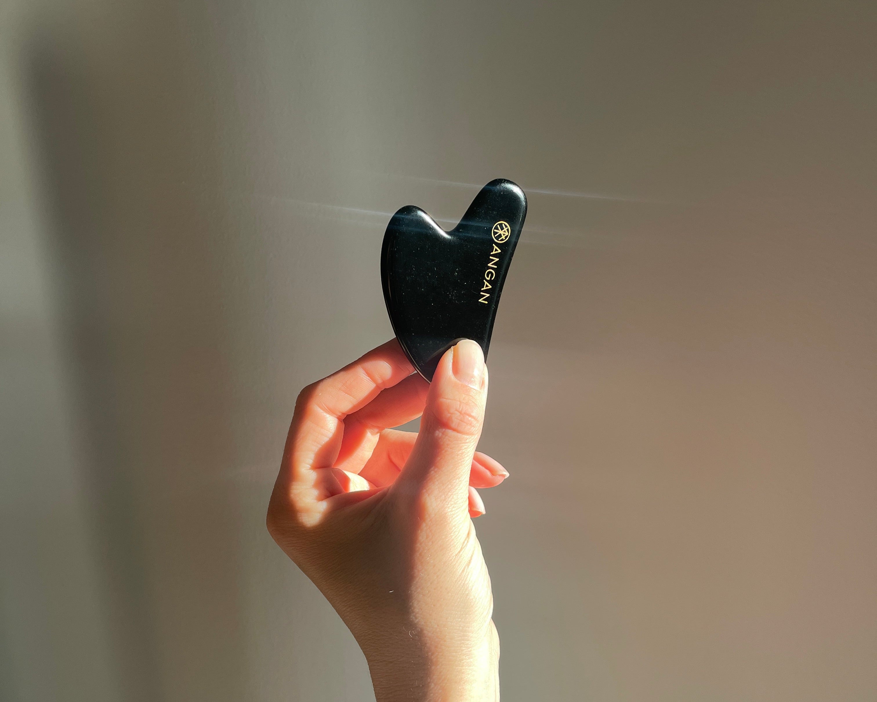 ANGAN Obsidian Gua Sha — ancient facial massage technique for sculpted, glowing skin