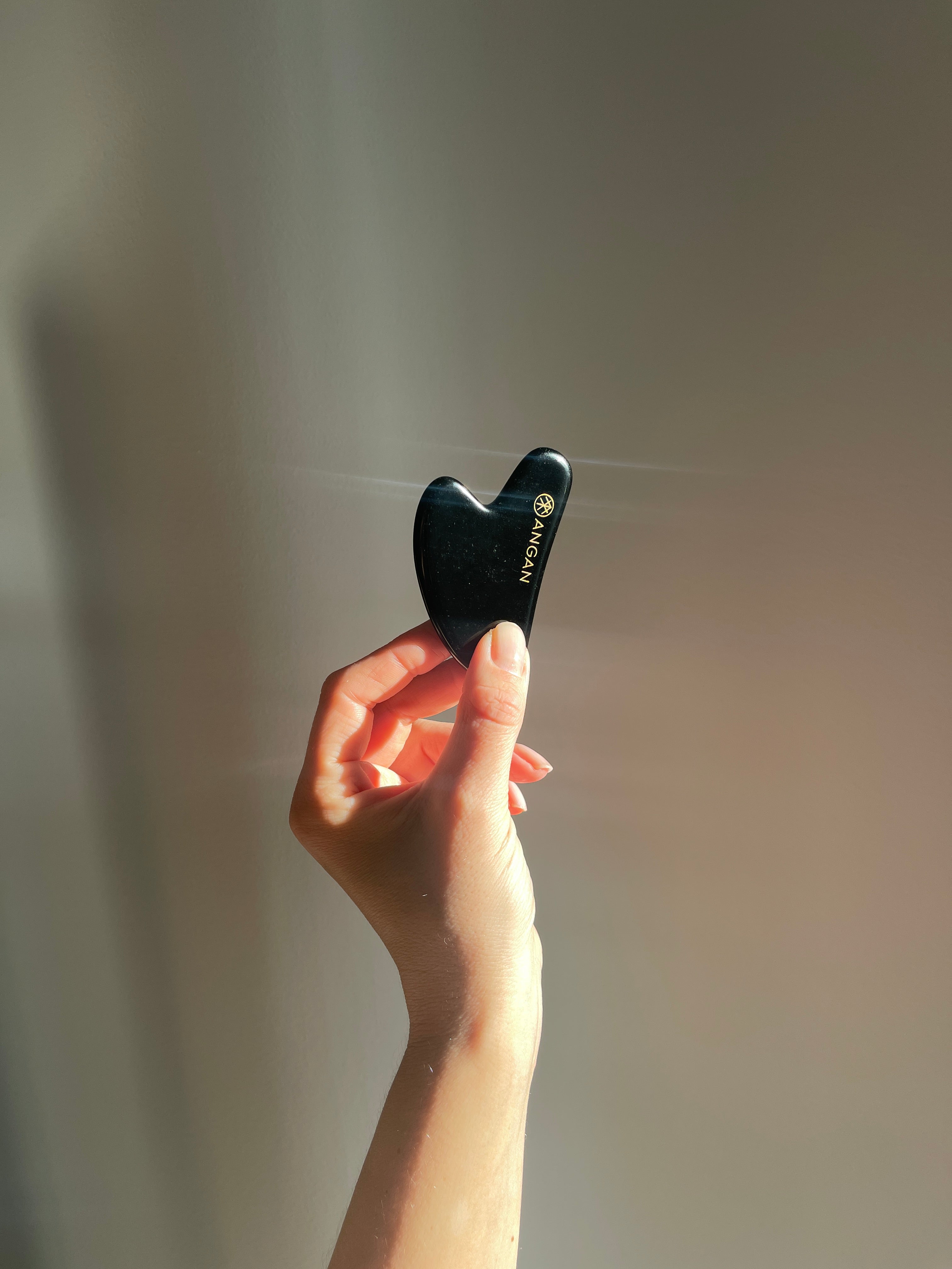 ANGAN Obsidian Gua Sha — ancient facial massage technique for sculpted, glowing skin