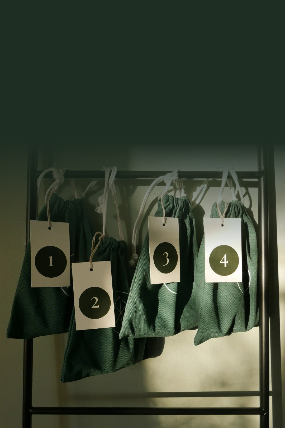 ANGAN Advent Calendar bags numbered one to four hanging on a ladder