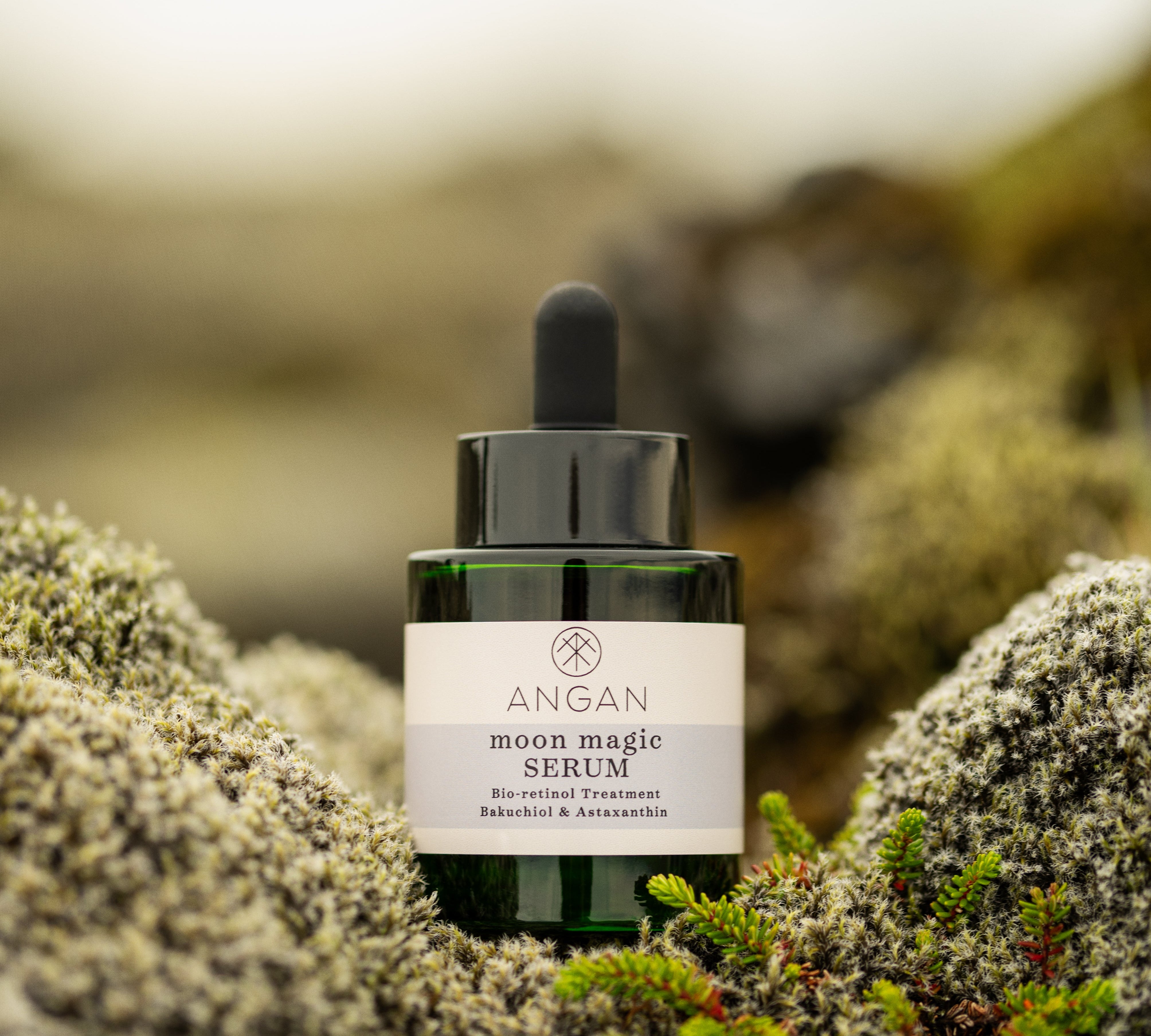 ANGAN Moon Magic Bio-Retinol Serum — bottle on mossy Icelandic landscape
