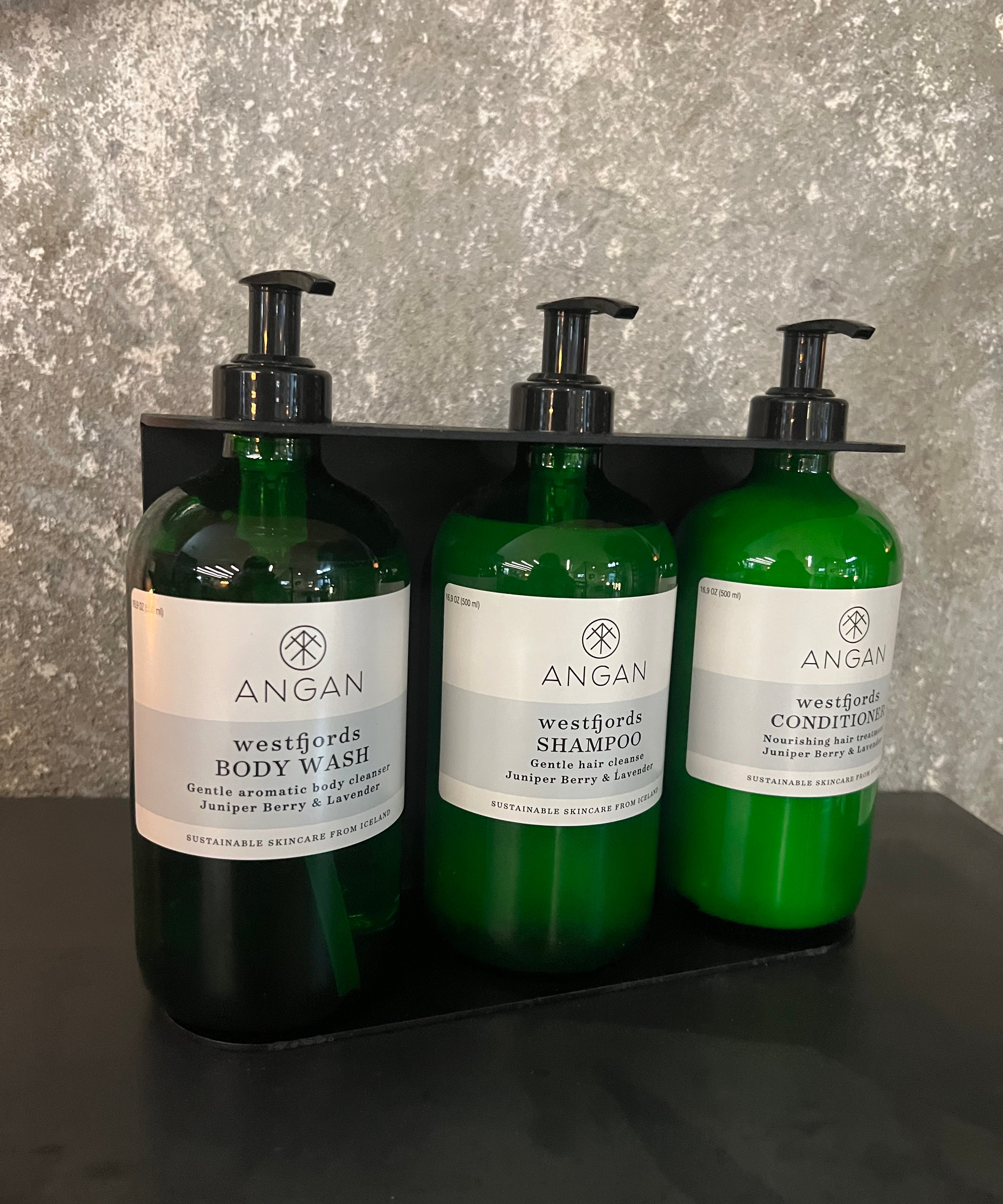 ANGAN Westfjords 3-bottle wall display — installed in spa or retail