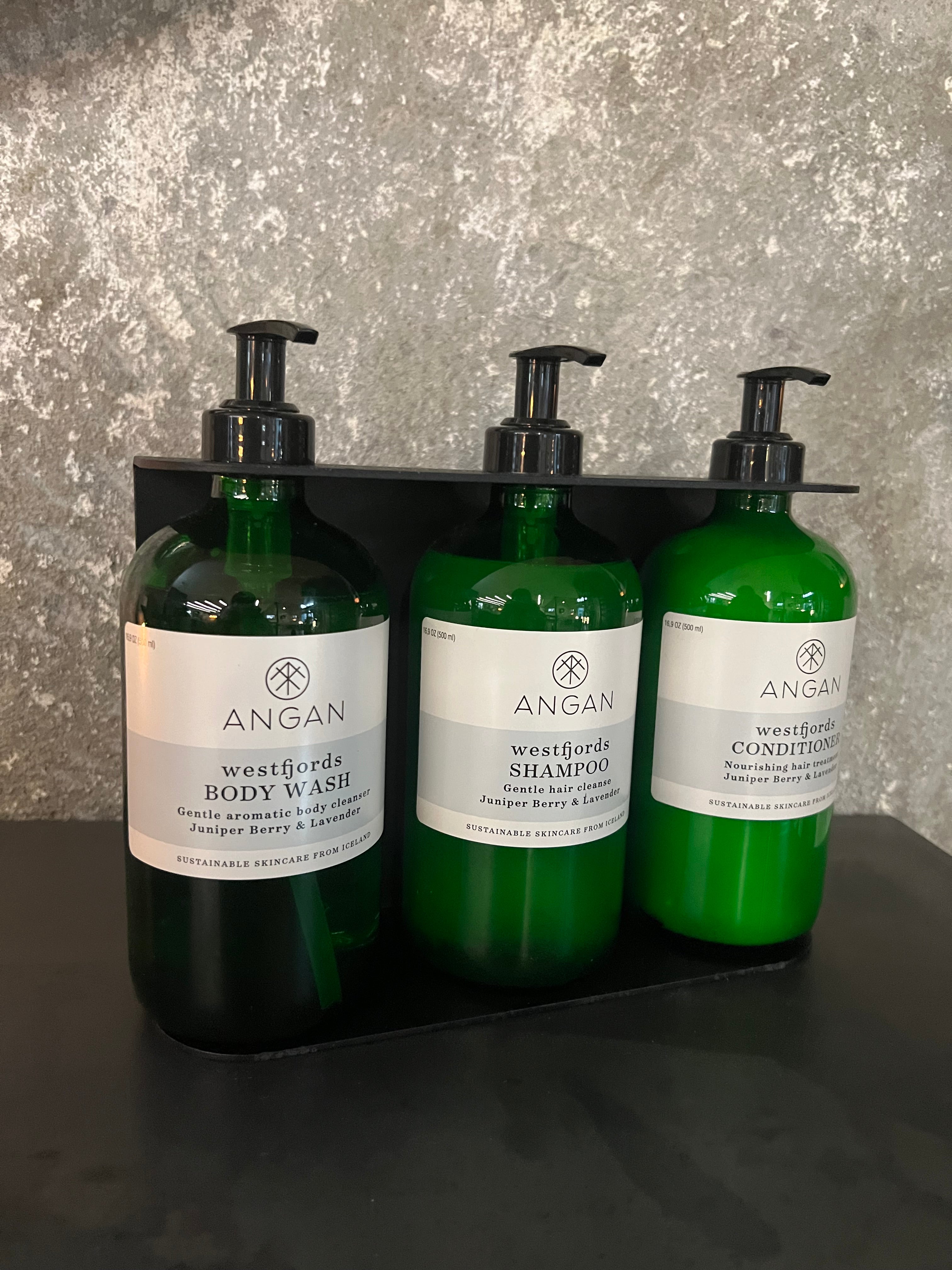 ANGAN Westfjords 3-bottle wall display — installed in spa or retail
